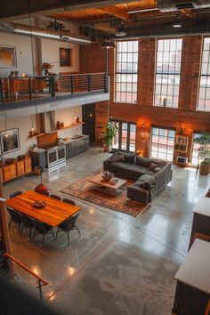 a large open living room with high ceilings and lots of windows on the second floor