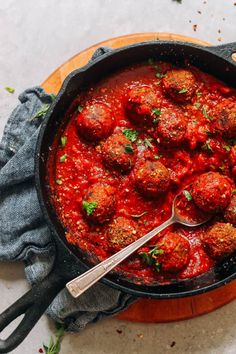 a skillet filled with meatballs covered in marinara sauce