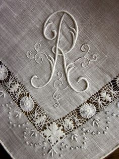 an embroidered monogram on a table cloth