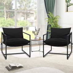 two black chairs sitting next to each other in front of a window