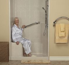 an older woman sitting in a shower with her feet up