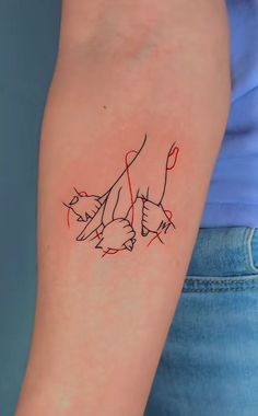 a woman's arm with a cat tattoo on the left side of her arm