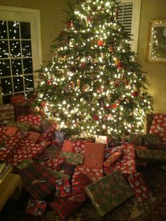 a christmas tree with presents under it