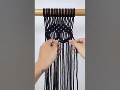 two hands are pulling the ends of a black and white curtain