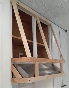 an unfinished kitchen cabinet is being built into the wall