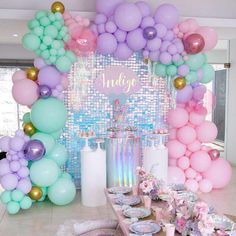 a table topped with lots of balloons and plates