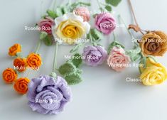 several crocheted flowers with names on them