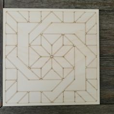 a piece of wood that has been cut into squares with lines in the middle and sides