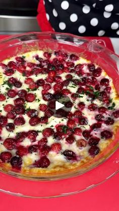 a pie with cherries on it sitting on top of a red tablecloth and white polka dots