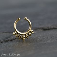 Unique and beautiful septum ring for non pierced nose. Tribal, ethnic, delicate design. Material: Gold Plated : Also available in sterling silver and brass, you can choose the material. Inner diameter: 8 mm - 0.31 Inc : The size can be adjusted according to your nose because it's a clip-on. Material: *Available in brass, sterling silver 925 and gold plated, you can choose the material. Measures: Width 12 mm- 0.47 Inc / Length - 14 mm - 0.55 Inc Also available in for pierced nose : https://www.et Handmade Bohemian Round Nose Rings, Bohemian Handmade Round Septum Ring, Handmade Bohemian Round Septum Ring, Bohemian Gold Nose Rings For Festival, Bohemian Gold Nose Rings Nickel Free, Bohemian Gold Septum Ring For Festivals, Bohemian Gold Nickel-free Nose Ring, Bohemian Hoop Septum Ring As Gift, Gold Bohemian Nickel-free Nose Ring