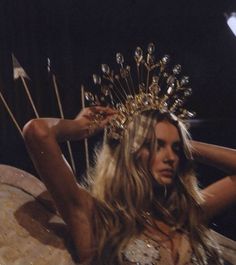 a woman wearing a headdress with arrows in her hair and the words mera written on it