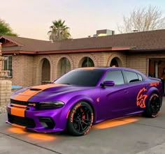 a purple and orange car parked in front of a house