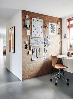 a home office with a cork board wall