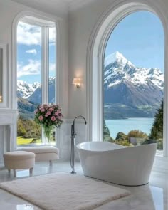 an elegant bathroom with large windows overlooking the mountains