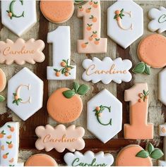 decorated cookies are arranged in the shape of letters and numbers for children's first birthdays