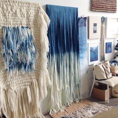 there are many pieces of art on display in this room, including blankets and rugs