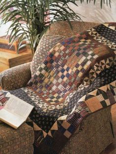 a patchwork chair with a book on it and a potted plant in the background