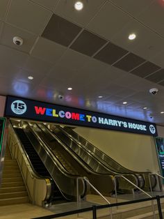 an escalator in a subway station with the sign welcome to harry's house