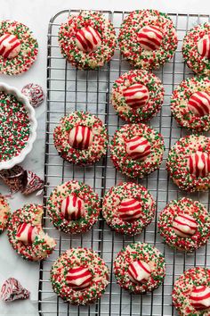 christmas sprinkle cookies on a cooling rack with candy canes and candies