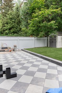 a backyard with a large checkered tile floor