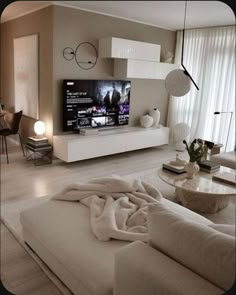 a living room filled with furniture and a flat screen tv on top of a wall