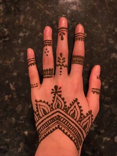 a hand with henna tattoos on it