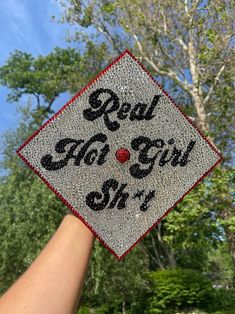 someone holding up a graduation cap that says real, no girl shy