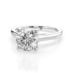 This beautiful round brilliant cut engagement ring features a minimalist fully polished plain aesthetic. The beautiful center stone stands proudly. Optional matching band is available. 1.5 carat center stone shown. This ring is made to order. Please select your options and allow 2-3 weeks for delivery. Plain Band Engagement Ring, Plain Aesthetic, Groomsmen Gifts Watches, Brilliant Cut Engagement Ring, Round Brilliant Cut Engagement Ring, Wedding Day Jewelry, Moissanite Engagement Ring Solitaire, Round Solitaire, Engagement Rings Platinum