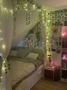 a bedroom decorated in white and green with fairy lights