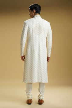 Off-white dupion silk sherwani with small paisley motif embroidery. Comes with a cotton silk kurta and churidar.
Component: 3
Pattern: Embroidered
Type Of Work: Paisley motifs
Neckline: Mandarin collar
Sleeve Type: Full
Fabric: Dupion silk, Kurta : Cotton silk
Color: Off White
Other Details: 
Front buttoned placket
Occasion: Groom, Wedding - Aza Fashions Motif Embroidery, Paisley Motifs, Kurta Cotton, Paisley Motif, Silk Kurta, Dupion Silk, Churidar, Embroidered Silk, Mandarin Collar