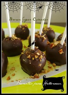 chocolate covered candies on a plate with white candles and sprinkled toppings