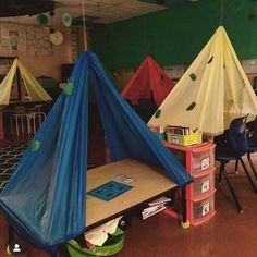 several tents are set up in a classroom