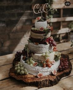 a wedding cake with grapes and cheese on top