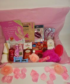 a pink gift box filled with personal care items