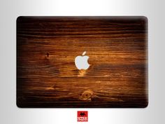 an apple logo on the side of a wooden macbook pro laptop computer skin sticker