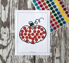 a card with dots on it next to a polka dot paper and some colored markers