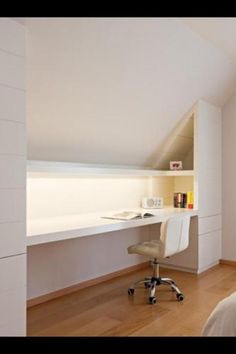 a bedroom with a bed, desk and chair next to a wall mounted book shelf