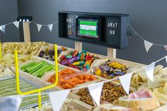 an assortment of snacks displayed in wooden trays with flags and bunting streamers