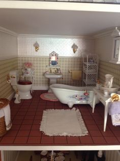 a bathroom with red tile flooring and white fixtures