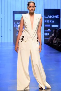 Experience a luxurious aspect in this white toned pant and jacket ensemble tailored with finesse,thoughtful addition of design elements and comfort silhouette cut. 
No of components: 2
Plain Jacket and Pant
Notch Lapel
Sleeveless
Padded Shoulder
Back Cut Out Detail
Dual Flap Pocket
Long Jacket
Semi Colon Detail
Comes With Pants - Aza Fashions Nikhil Thampi, Plain Jacket, Pant For Women, Lapel Jacket, Lakme Fashion Week, Indian Fashion Designers, Matching Pants, Celebrity Look, Silhouette Cut