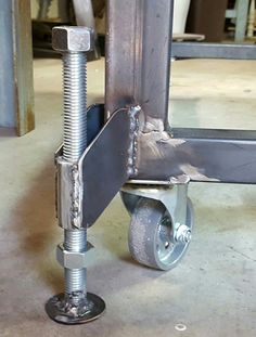 the wheel is attached to the metal frame with screws and nuts on each side