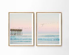 two framed pictures with birds flying over the ocean and pier in the distance at sunset