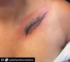 a woman's chest with a small feather tattoo on the left side of her breast