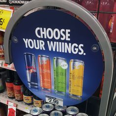 a sign that says choose your wings on the side of a shelf in a store