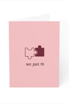 a pink greeting card with the words we just fit and a puzzle piece on it