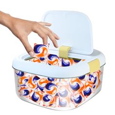 a hand reaching for something in an ice chest with colorful swirls on the lid