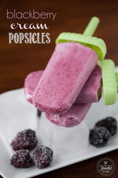 blackberry ice cream popsicles on a white plate