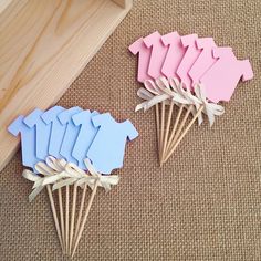 several pieces of paper with clothes pins attached to them sitting on the floor next to a wooden box