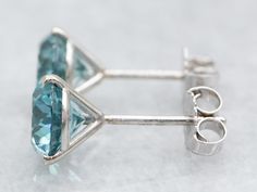 Elevate your look with these stunning white gold stud earrings, featuring beautiful blue zircon gems. The classic stud setting and timeless design will ensure these earrings are a timeless fashion piece. Metal: 14K White GoldGem: 2 Blue Zircon totaling 1.68 CaratsGem Measurements: 6.5 mm, RoundMarks: "14K" Stamped on the posts Timeless Fashion Pieces, White Gold Stud Earrings, White Gold Studs, White Gold Earrings Studs, Gold Stud Earrings, Stud Set, Watch Chain, Blue Zircon, Gold Stud