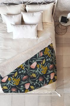 an overhead view of a bed with pillows and blankets